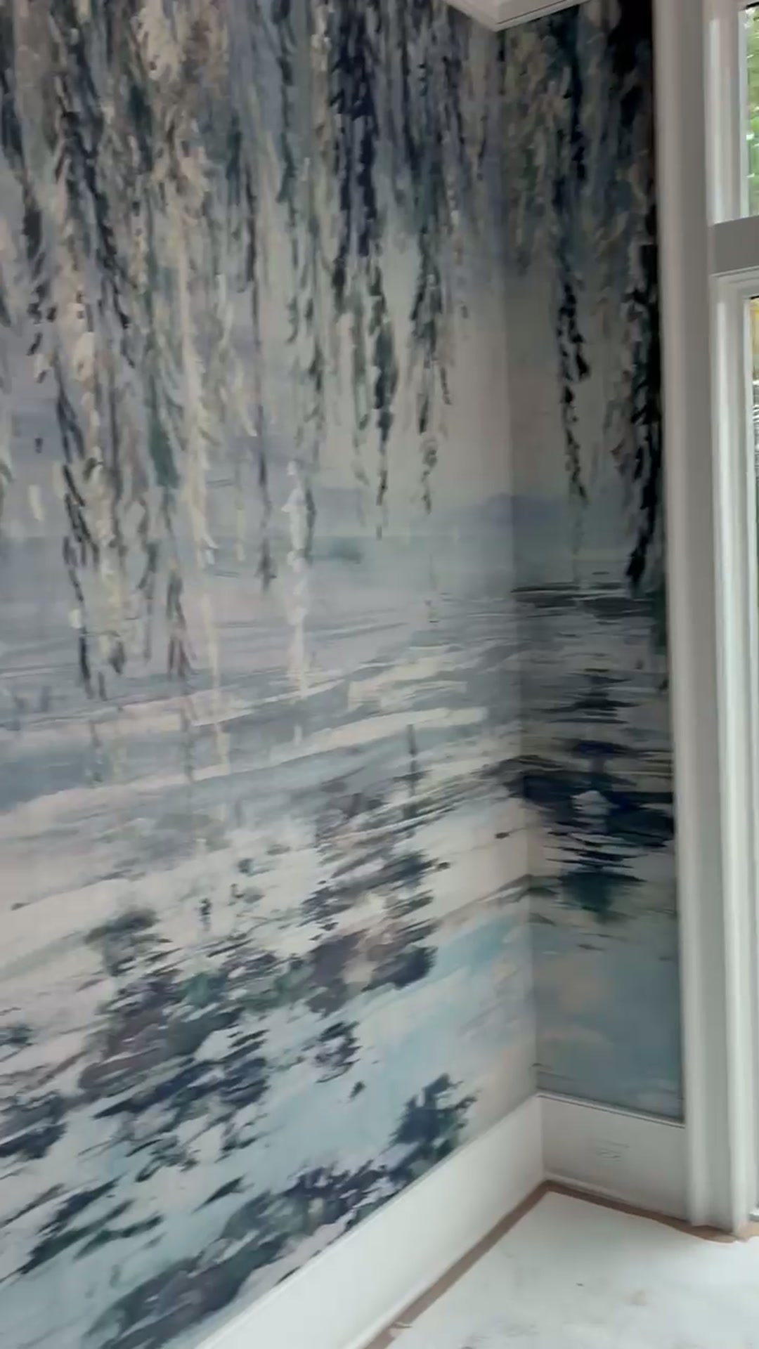 Weeping willow and water reflection mural wrapping an inside corner between two windows