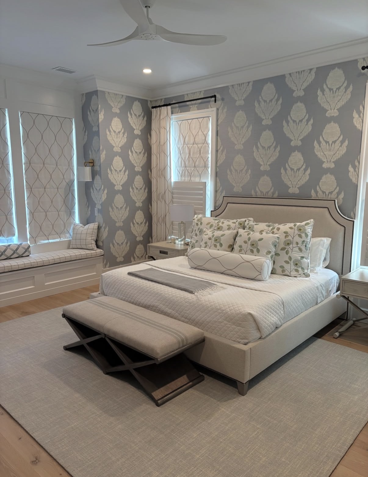 Grey and cream ikat medallion grasscloth wallpaper wrapping a primary bedroom